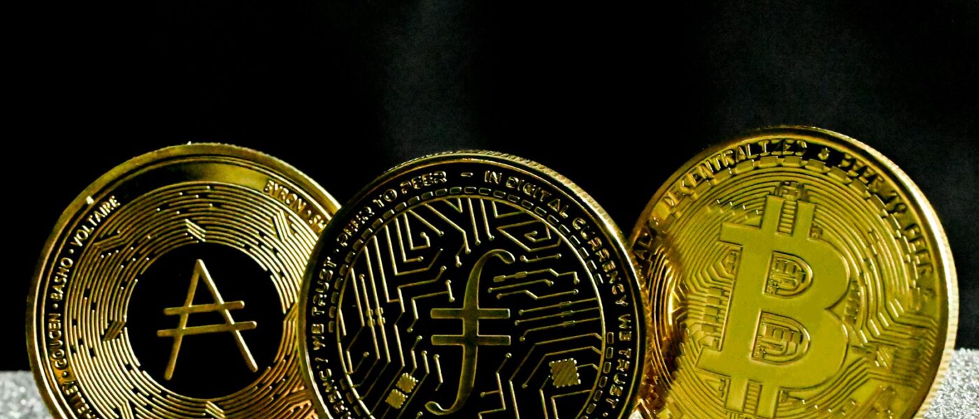 three gold bitcoins sitting next to each other