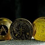 three gold bitcoins sitting next to each other