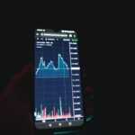 a person holding a cell phone in their hand