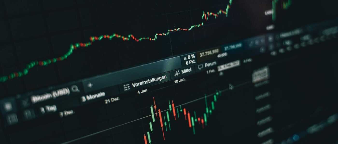 Close-up of a digital market analysis display showing Bitcoin and cryptocurrency price trends.