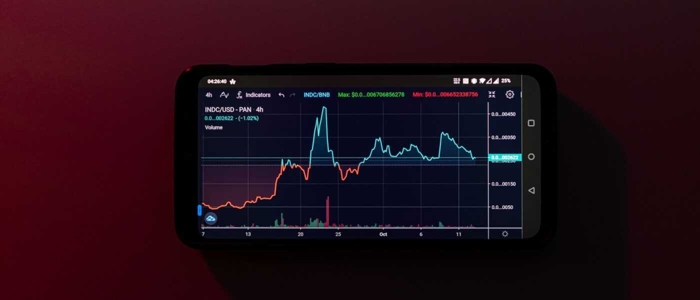 a cell phone displaying a stock chart on a red background
