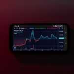 a cell phone displaying a stock chart on a red background