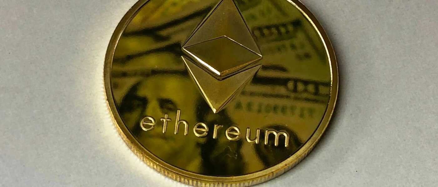 Close-up of a shining Ethereum coin reflecting a dollar bill, symbolizing digital currency and wealth.