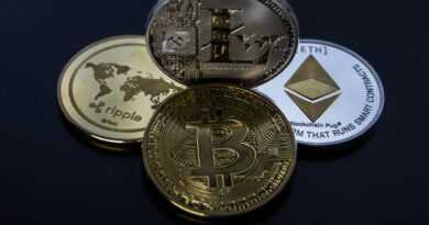 Detailed photo showcasing bitcoin, ethereum, litecoin, and ripple coins representing digital currency.