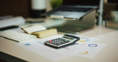 a calculator sitting on top of a table next to a laptop