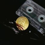 a bitcoin is sitting on top of a pair of scissors