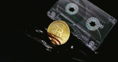 a bitcoin is sitting on top of a pair of scissors