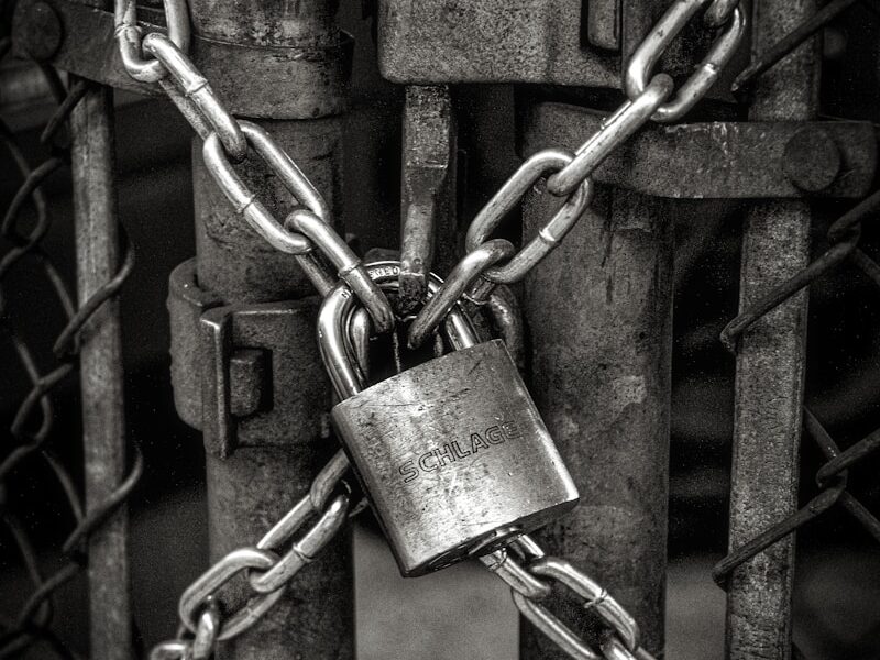 gray steel chain locked on gate