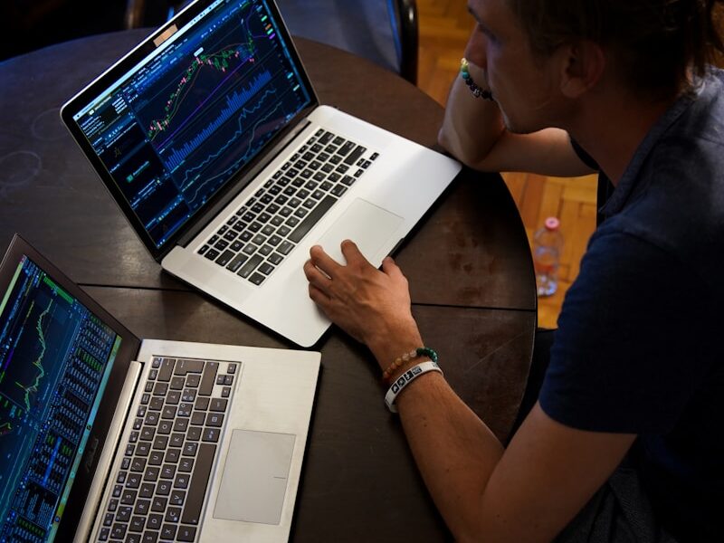 man sitting in front of the MacBook Pro