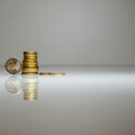 a stack of coins sitting on top of a reflective surface