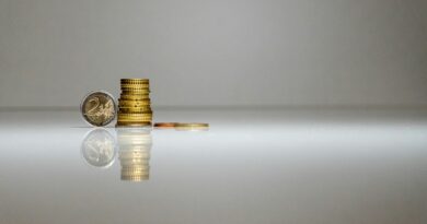 a stack of coins sitting on top of a reflective surface