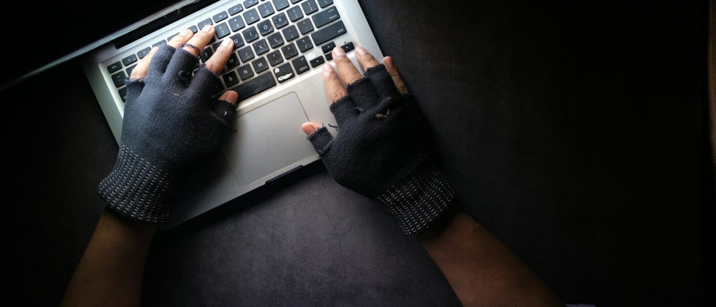 person in black long sleeve shirt using macbook pro