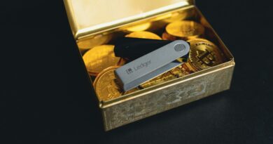 a swiss army knife sitting in a box of gold coins
