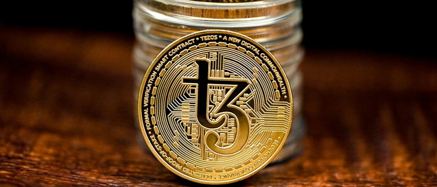 a stack of coins sitting on top of a wooden table
