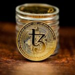 a stack of coins sitting on top of a wooden table