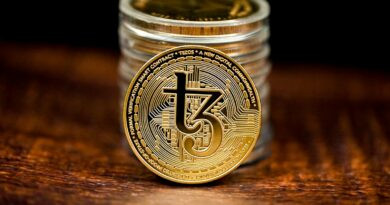 a stack of coins sitting on top of a wooden table