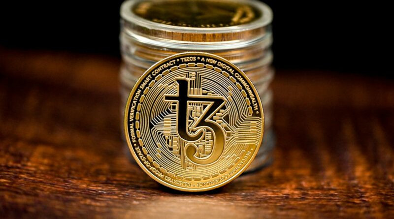 a stack of coins sitting on top of a wooden table