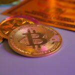 Golden bitcoin coin with other coins and card.
