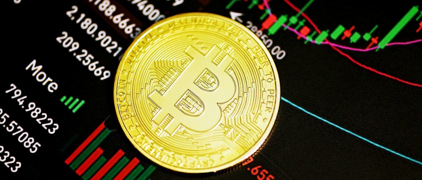 gold round coin on black surface