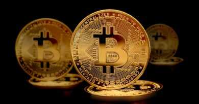 a group of gold bitcoins sitting on top of each other