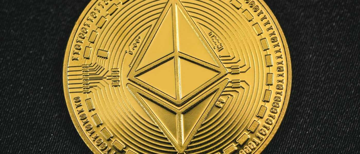 a gold coin with the symbol of ether on it
