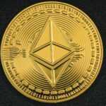 a gold coin with the symbol of ether on it