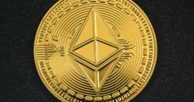 a gold coin with the symbol of ether on it