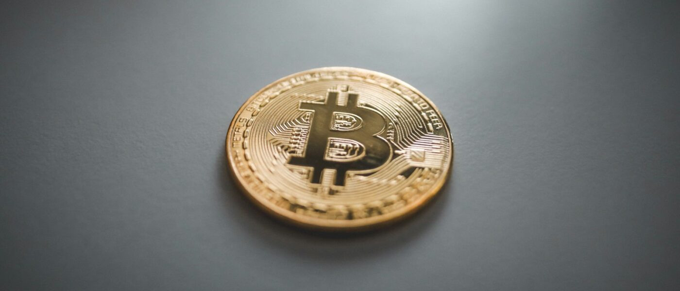 gold round coin on gray surface