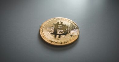 gold round coin on gray surface