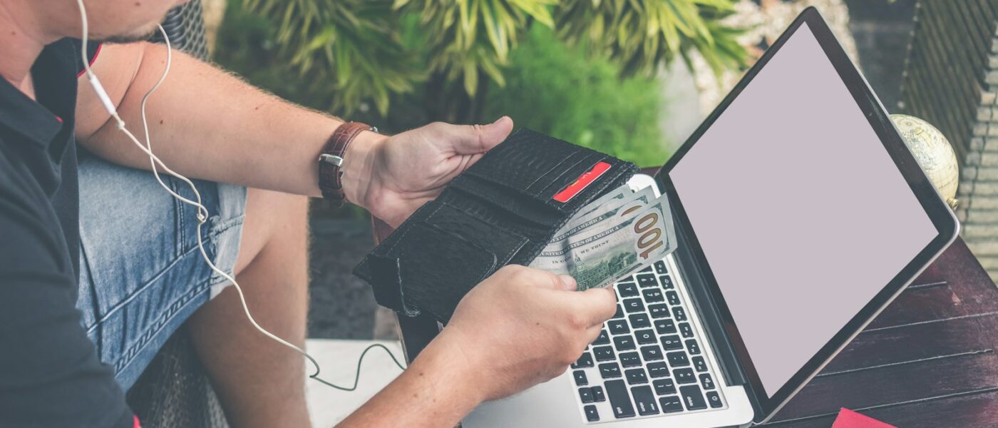 man holding black leather wallet