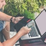 man holding black leather wallet