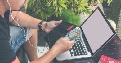 man holding black leather wallet