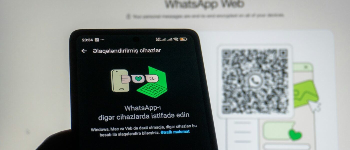 Phone scanning whatsapp web qr code on screen