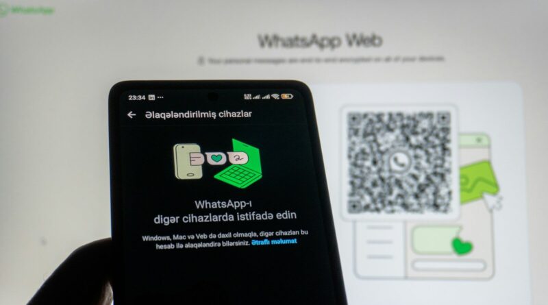 Phone scanning whatsapp web qr code on screen